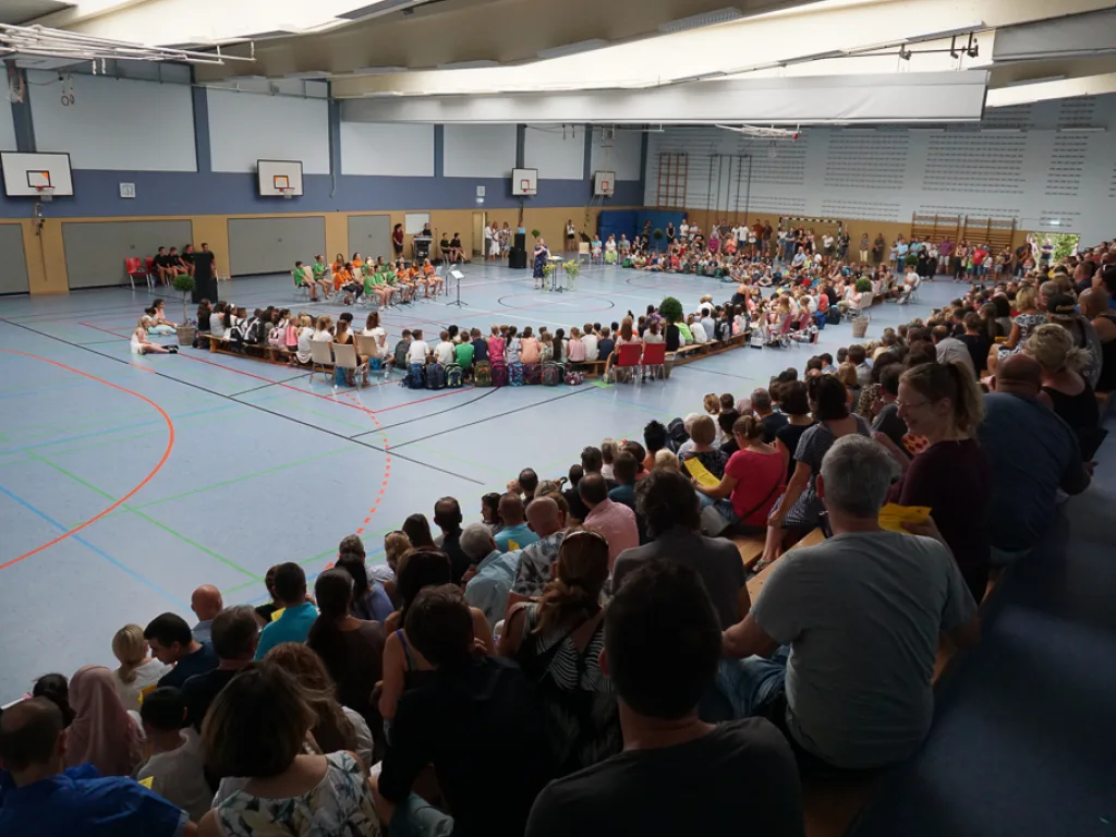 Weite Aufnahme der voll besetzten Halle.
